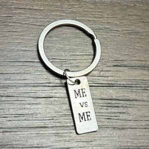 Silver Keychain with 'ME VS ME' Tag